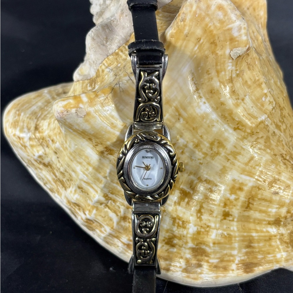 Women’s rumors watch. With silver and black and gold  inlays. Runs greater/ batt